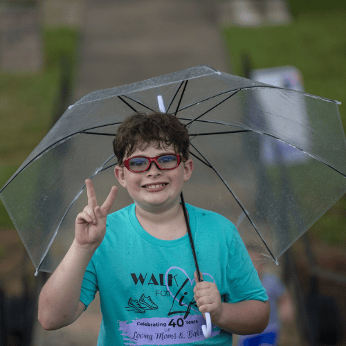boy with glasses and umbrella fundraiser